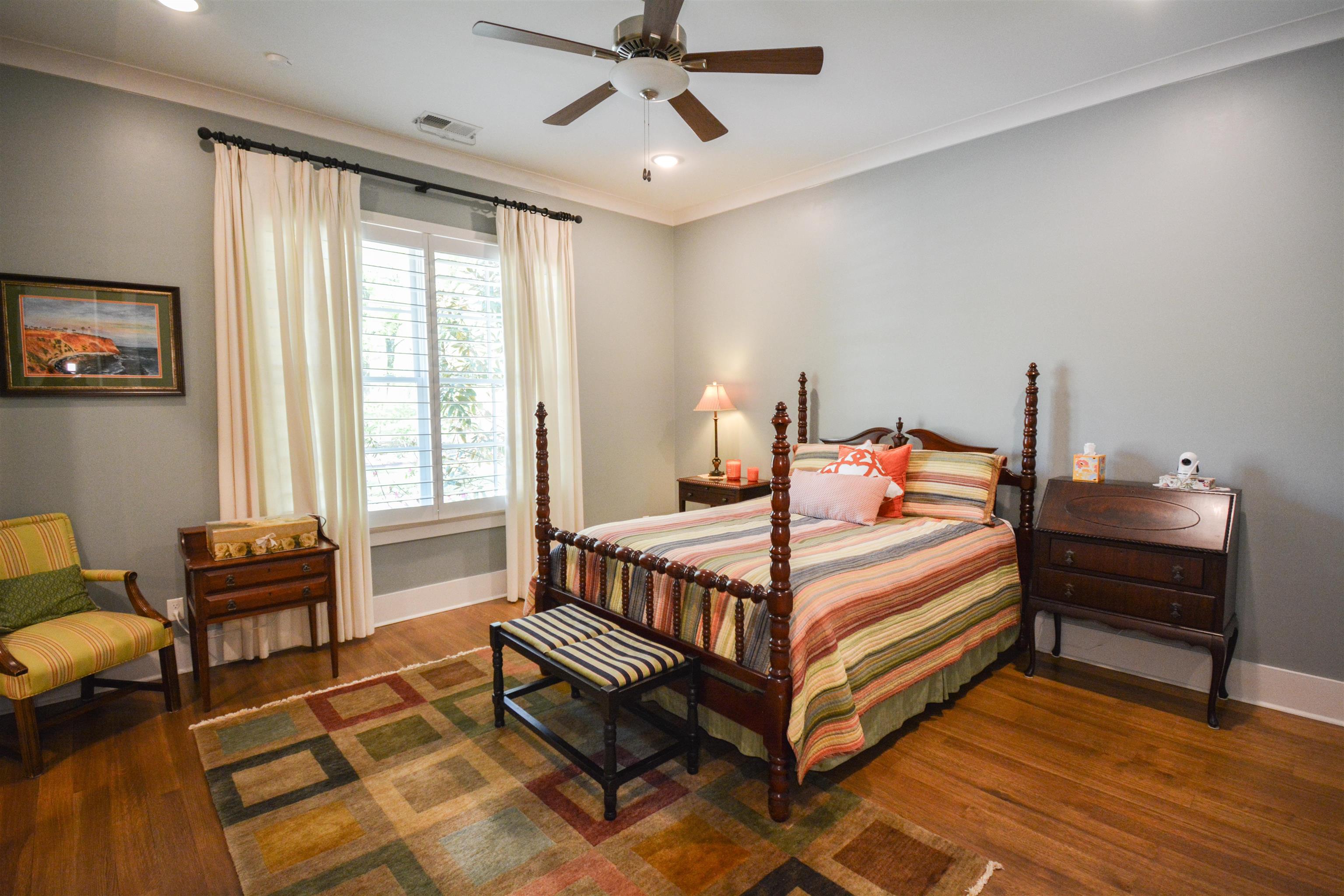 5293 Cole Road Memphis, TN 38120 - Photo 20 of 40 a bedroom with a bed and a chandelier