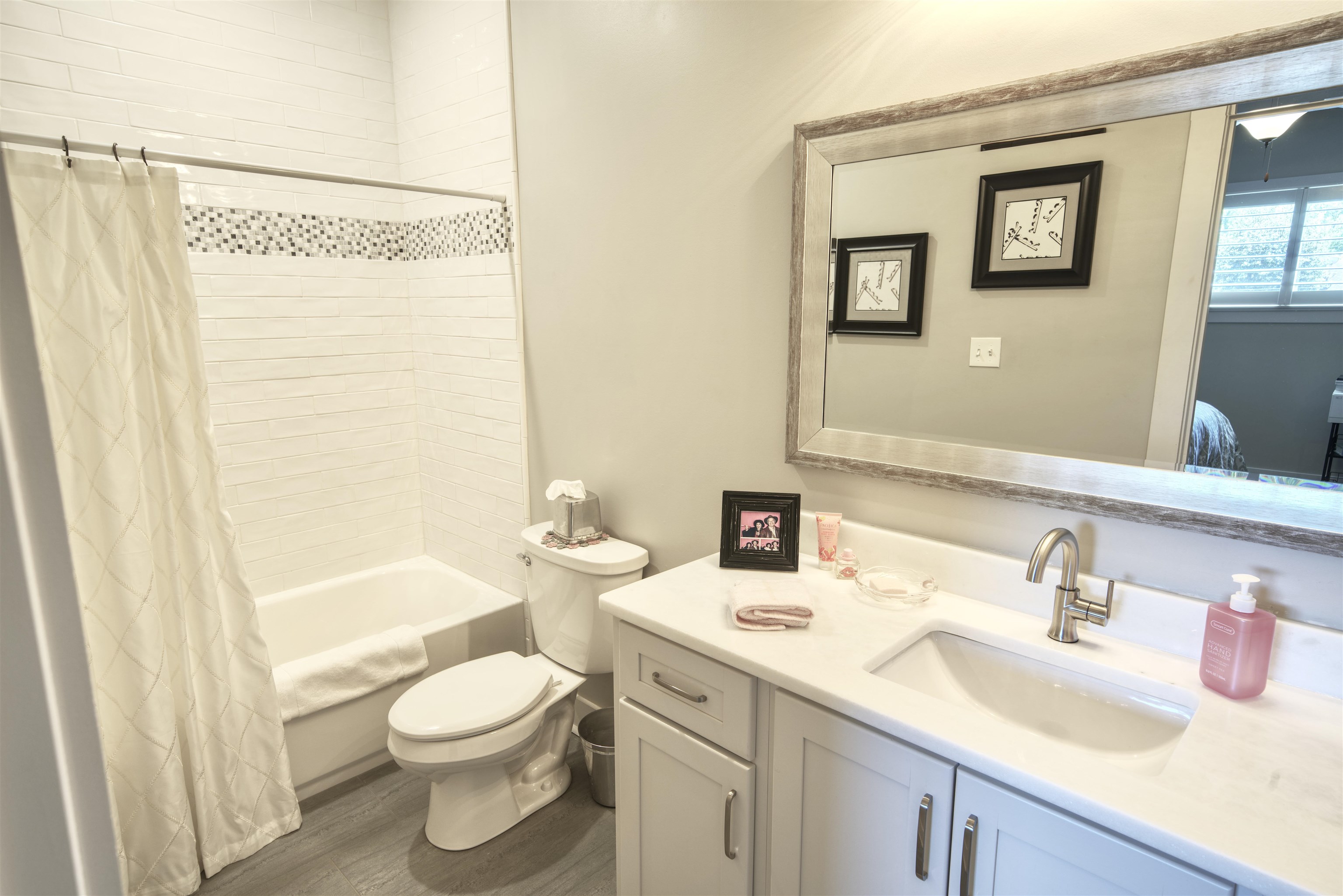 5293 Cole Road Memphis, TN 38120 - Photo 25 of 40 a bathroom with a sink a toilet and shower curtain