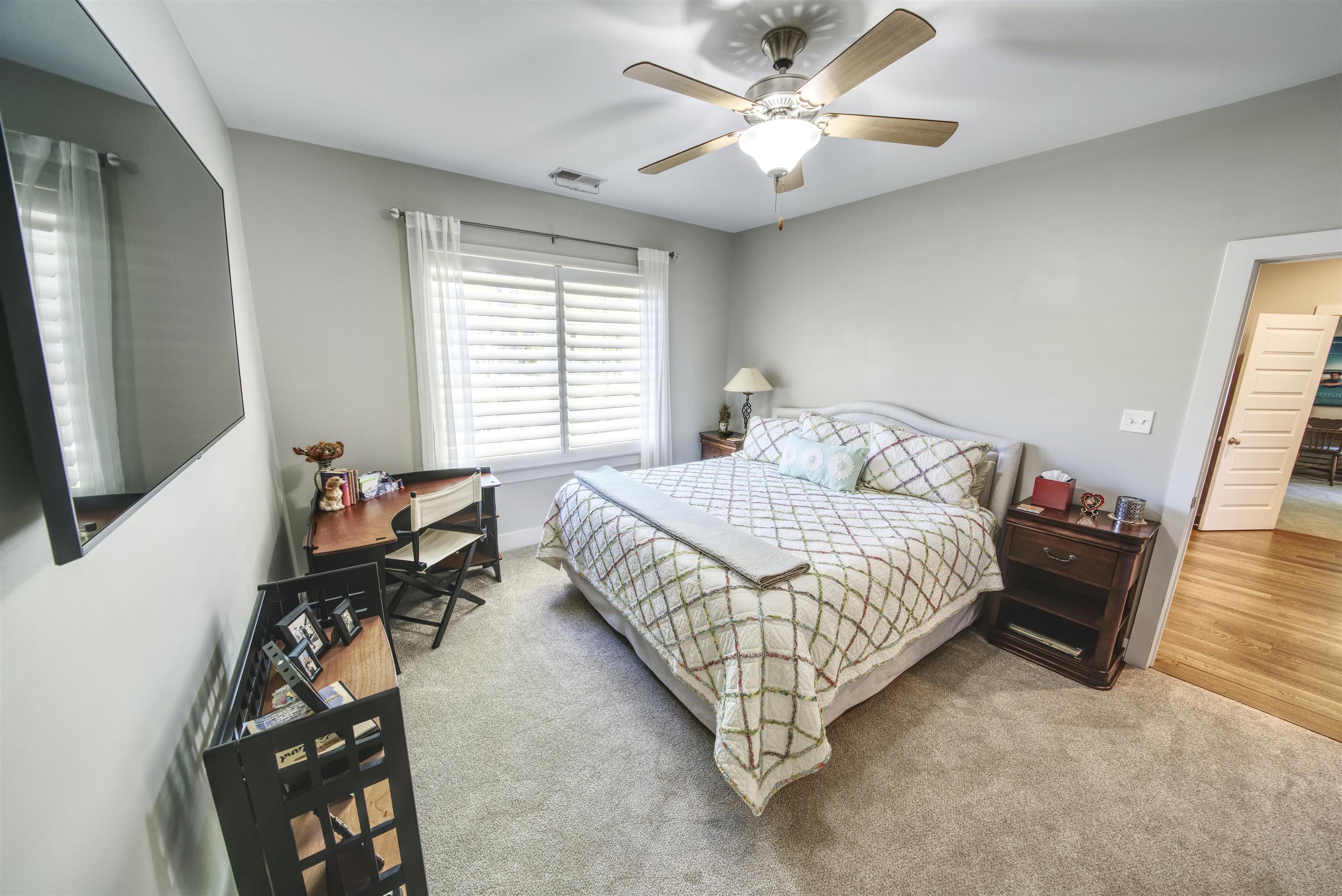 5293 Cole Road Memphis, TN 38120 - Photo 27 of 40 a bedroom with a bed and a chandelier