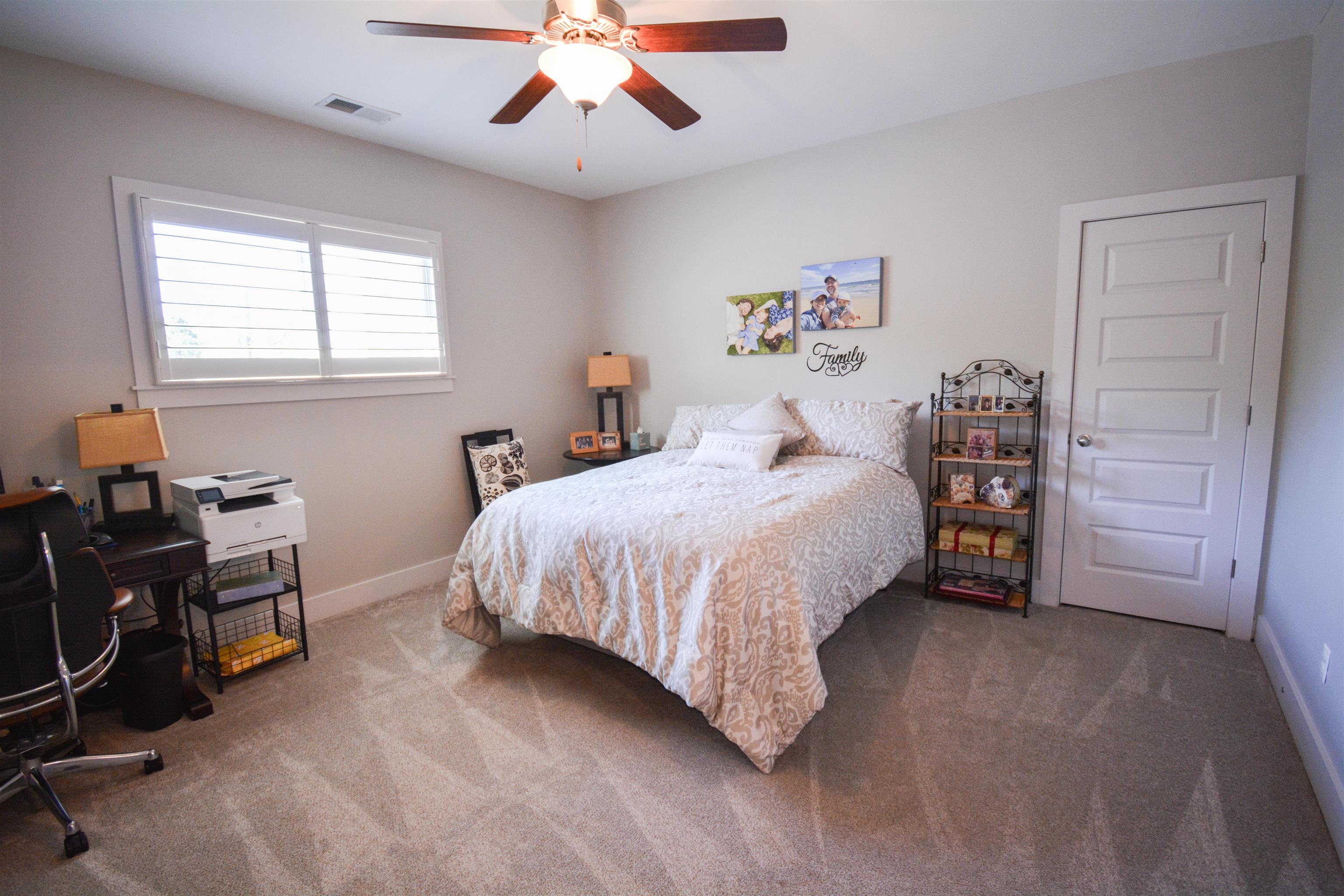 5293 Cole Road Memphis, TN 38120 - Photo 38 of 40 a bedroom with a bed and a chandelier