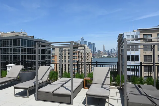 a view of a balcony with two chairs and a table