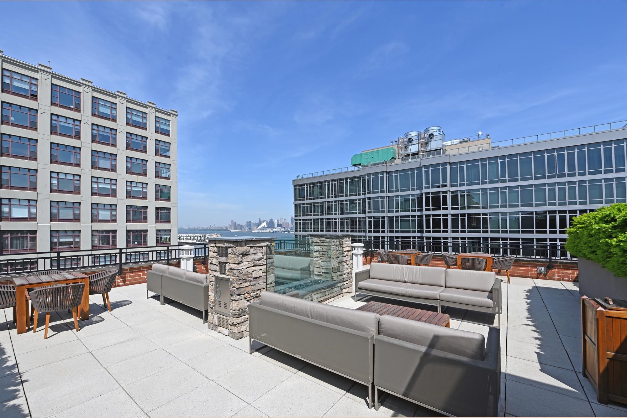 1450 Washington Street, Unit 609 Hoboken, NJ 07030 - Photo 14 of 30 a view of a roof deck with couches and iron fence