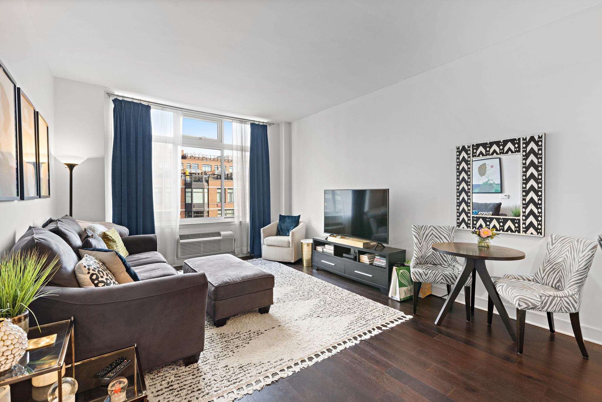 1450 Washington Street, Unit 609 Hoboken, NJ 07030 - Photo 2 of 30 a living room with furniture flat screen tv and wooden floor