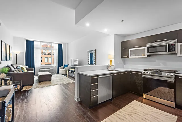 a open kitchen with stainless steel appliances granite countertop a stove and a sink