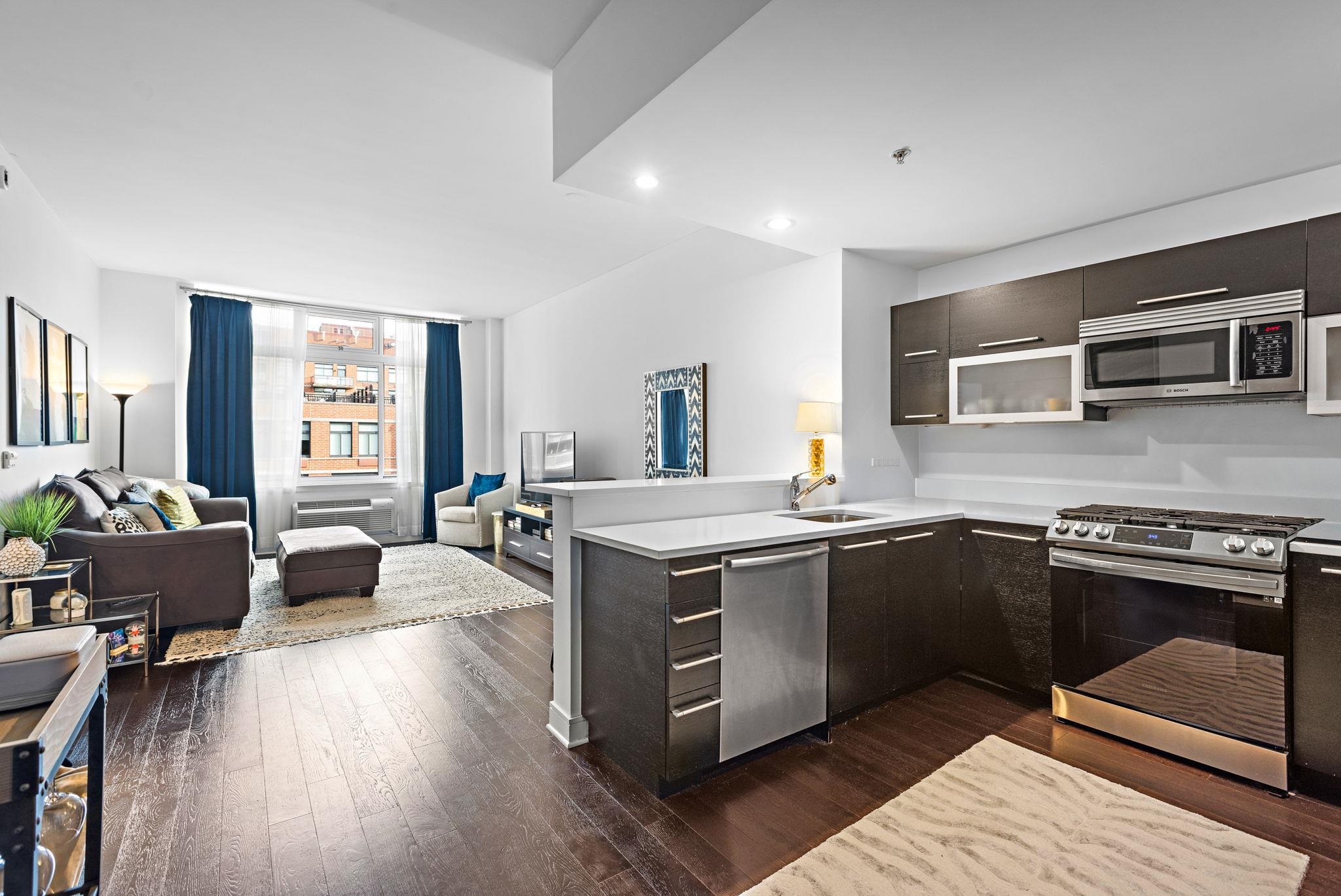 1450 Washington Street, Unit 609 Hoboken, NJ 07030 - Photo 3 of 30 a open kitchen with stainless steel appliances granite countertop a stove and a sink