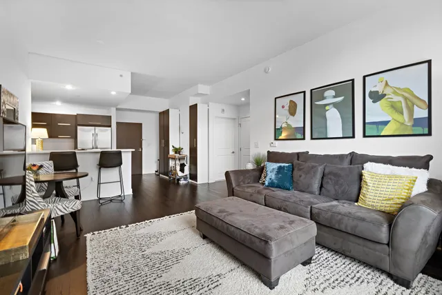 a living room with furniture and painting on the wall