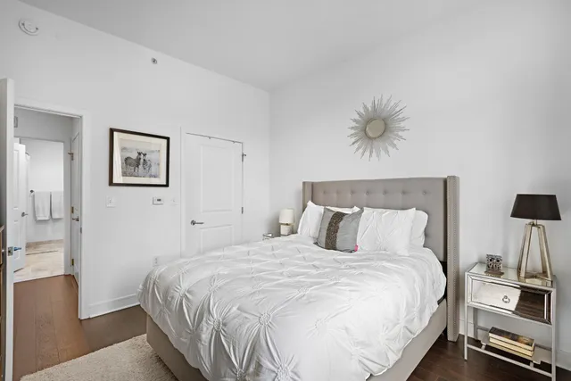 a bedroom with a bed and a chandelier