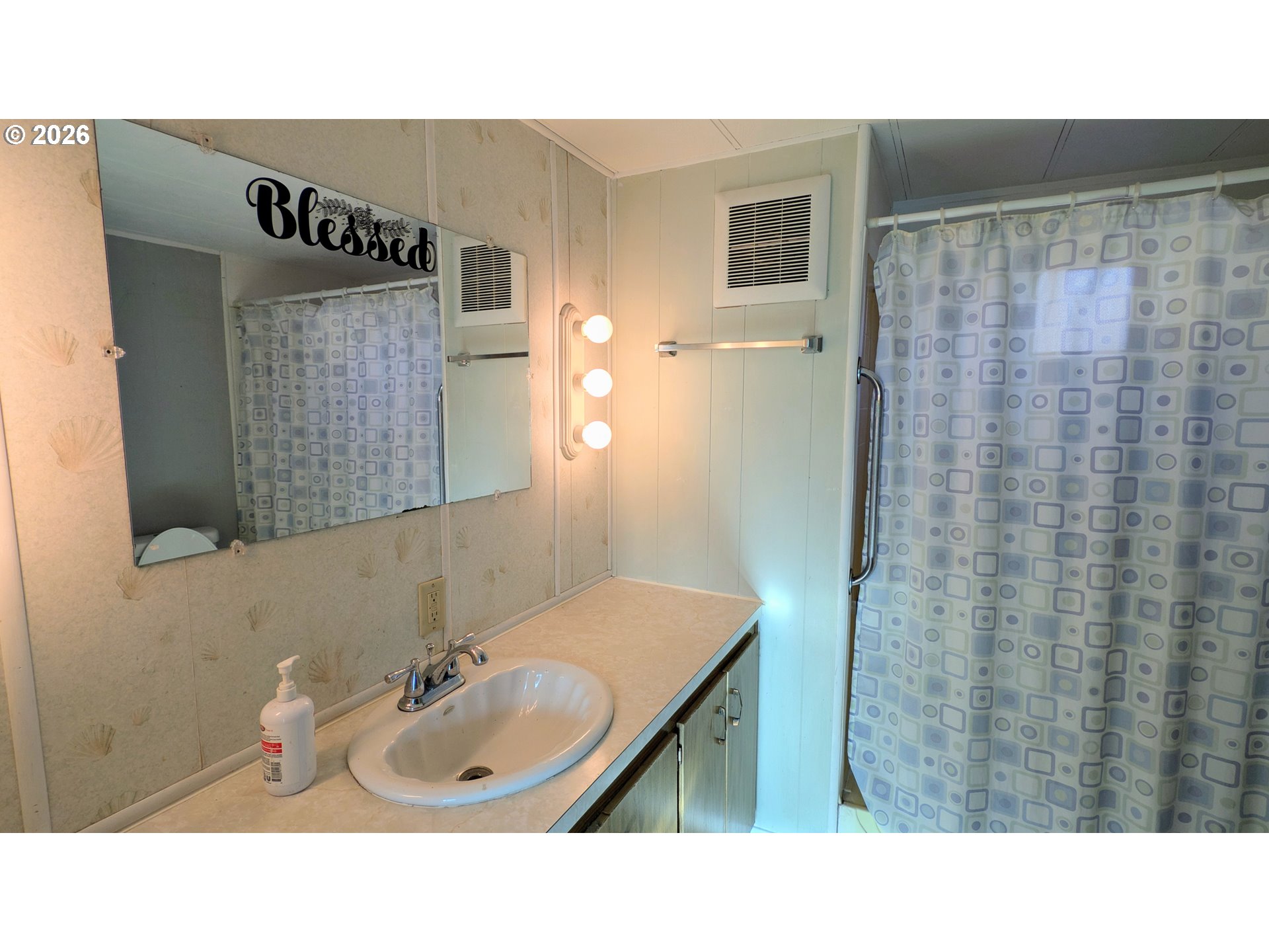 3203 Southeast Vineyard Road, Unit 12 Milwaukie, OR 97267 - Photo 13 of 20 a bathroom with a sink and a mirror