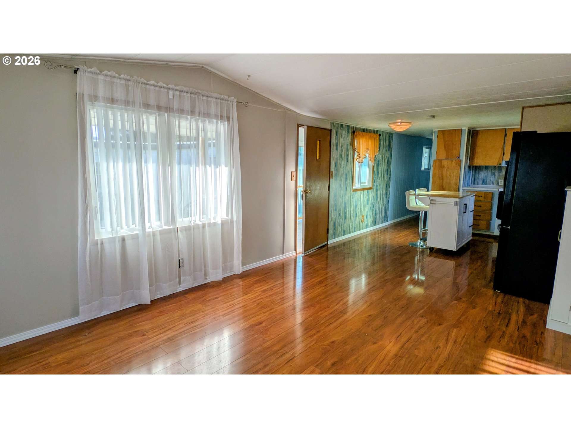 3203 Southeast Vineyard Road, Unit 12 Milwaukie, OR 97267 - Photo 6 of 20 a living room with furniture window and wooden floor