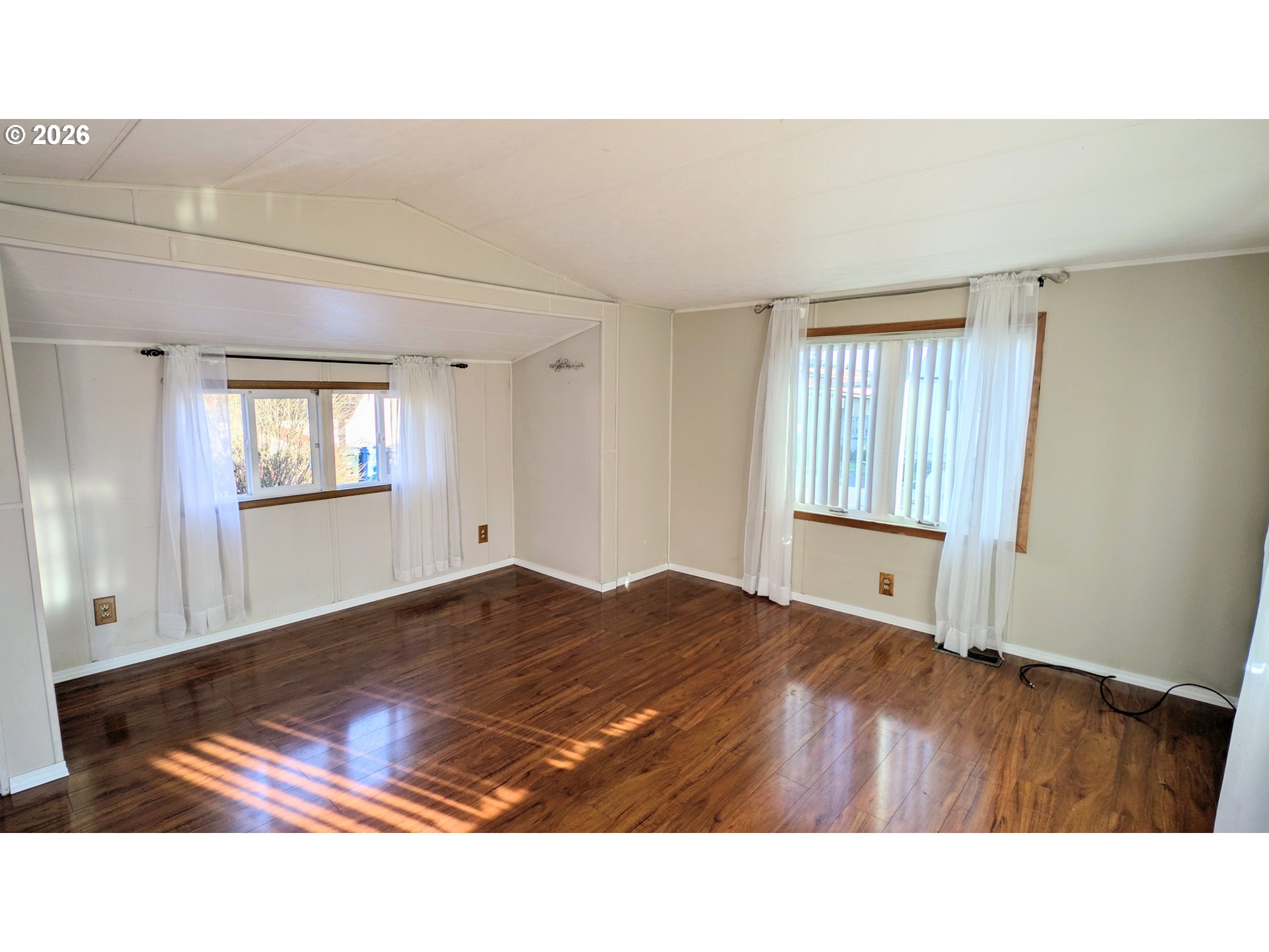 3203 Southeast Vineyard Road, Unit 12 Milwaukie, OR 97267 - Photo 7 of 20 a living room with a bed furniture and a window