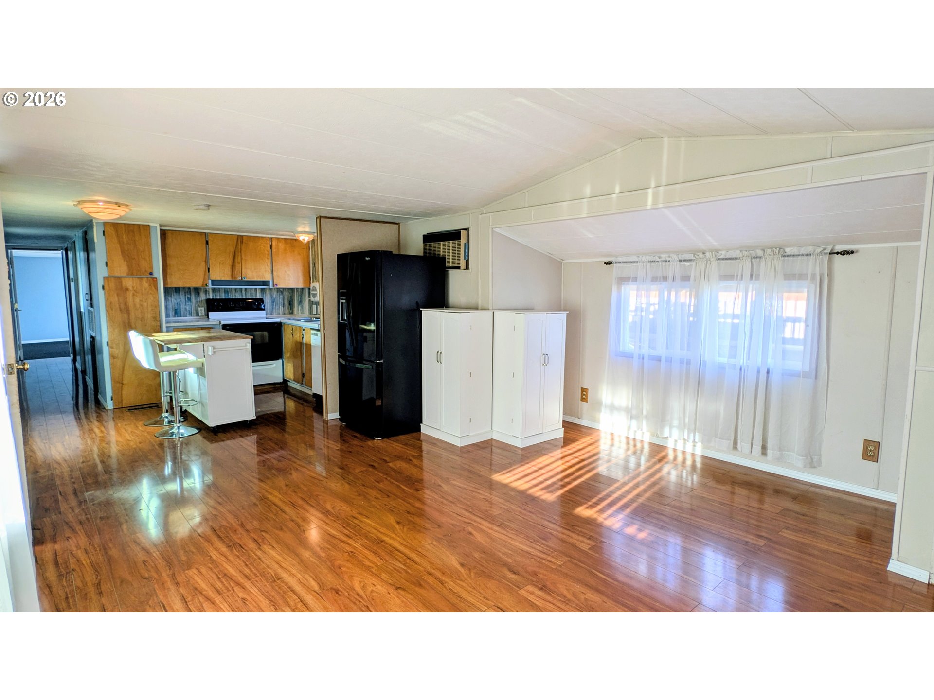 3203 Southeast Vineyard Road, Unit 12 Milwaukie, OR 97267 - Photo 8 of 20 a living room with a couch and a wooden floor