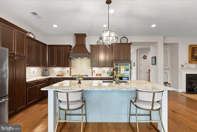 a living room with furniture wooden floor and a flat screen tv
