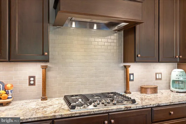 a living room with furniture kitchen view and a large window