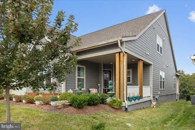 a bedroom with a bed a couch and a window