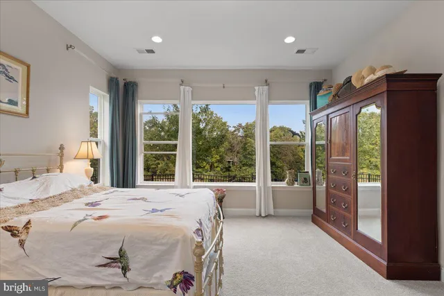 a bedroom with a large bed and a large window