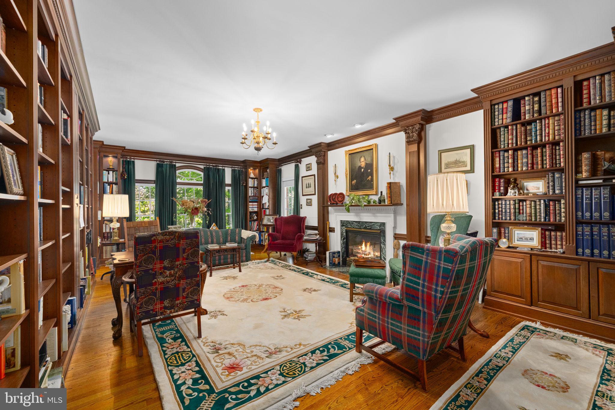 897 Chinquapin Road McLean, VA 22102 - Photo 12 of 66 a living room with furniture a bookshelf and a large window