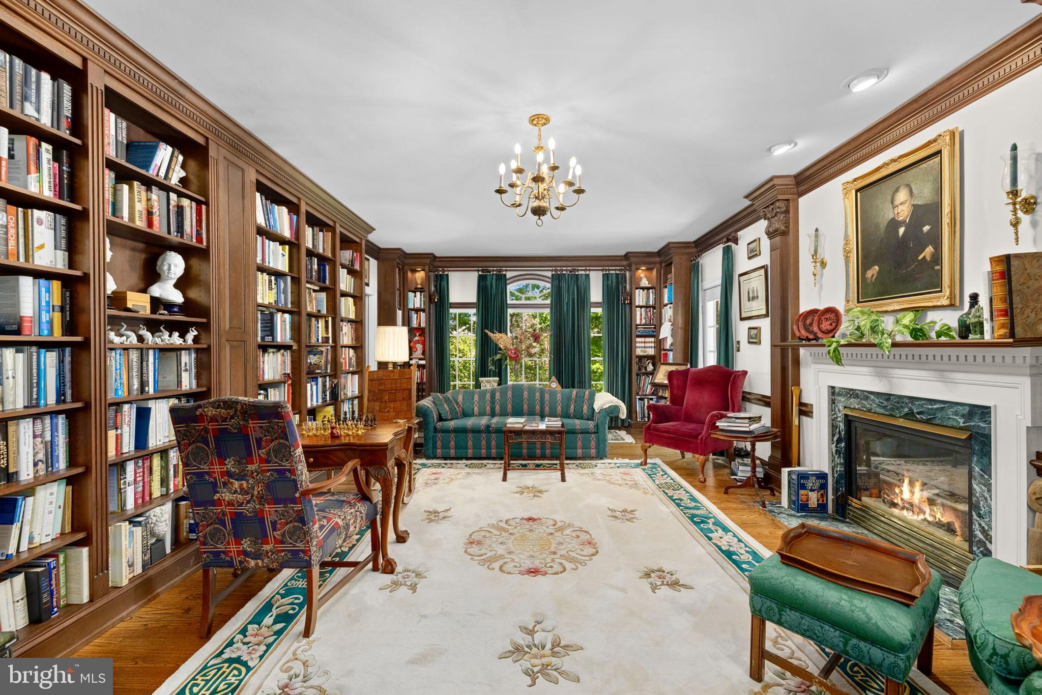 897 Chinquapin Road McLean, VA 22102 - Photo 13 of 66 a living room with furniture a bookshelf and a fireplace