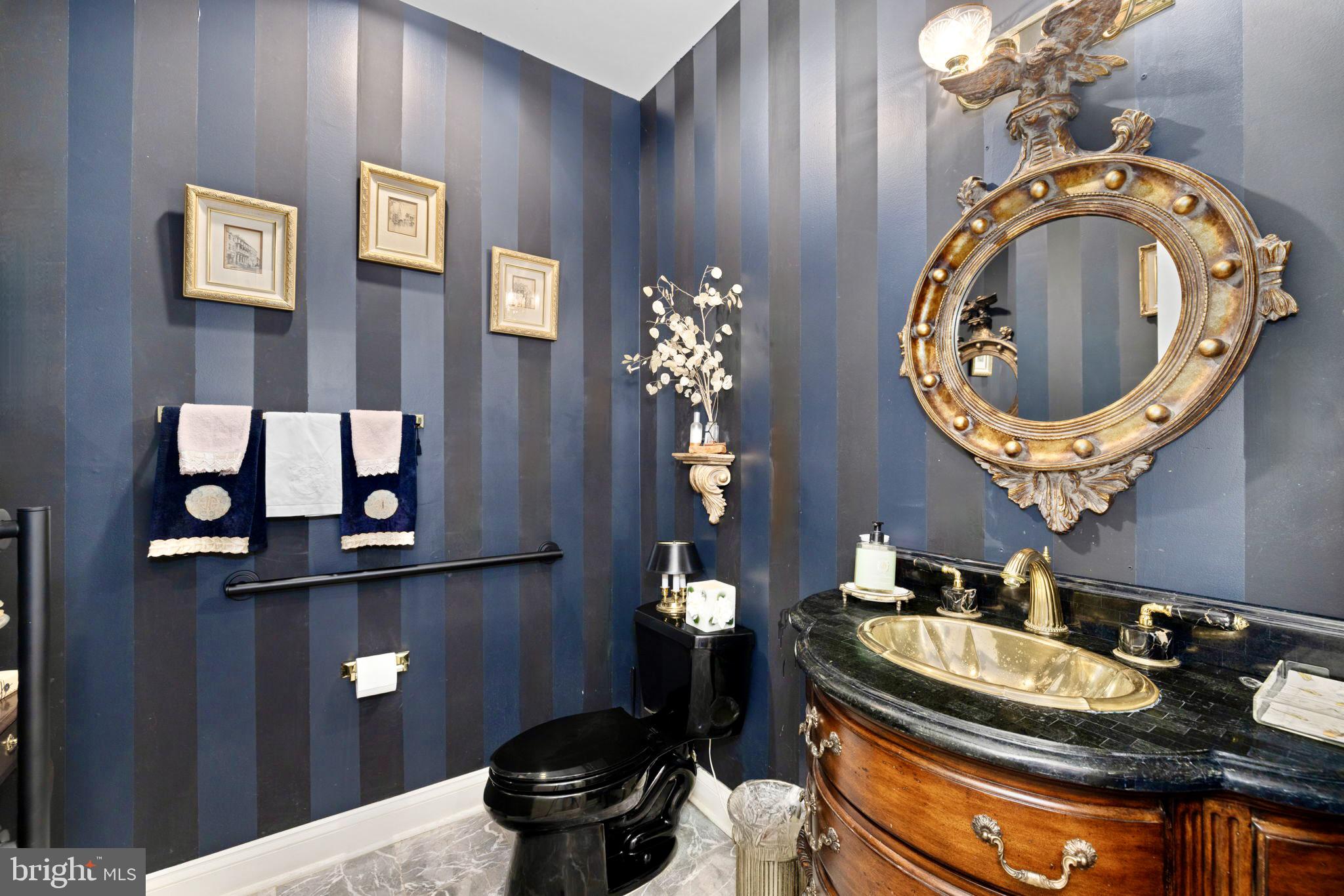 897 Chinquapin Road McLean, VA 22102 - Photo 31 of 66 a bathroom with a toilet mirror and vanity