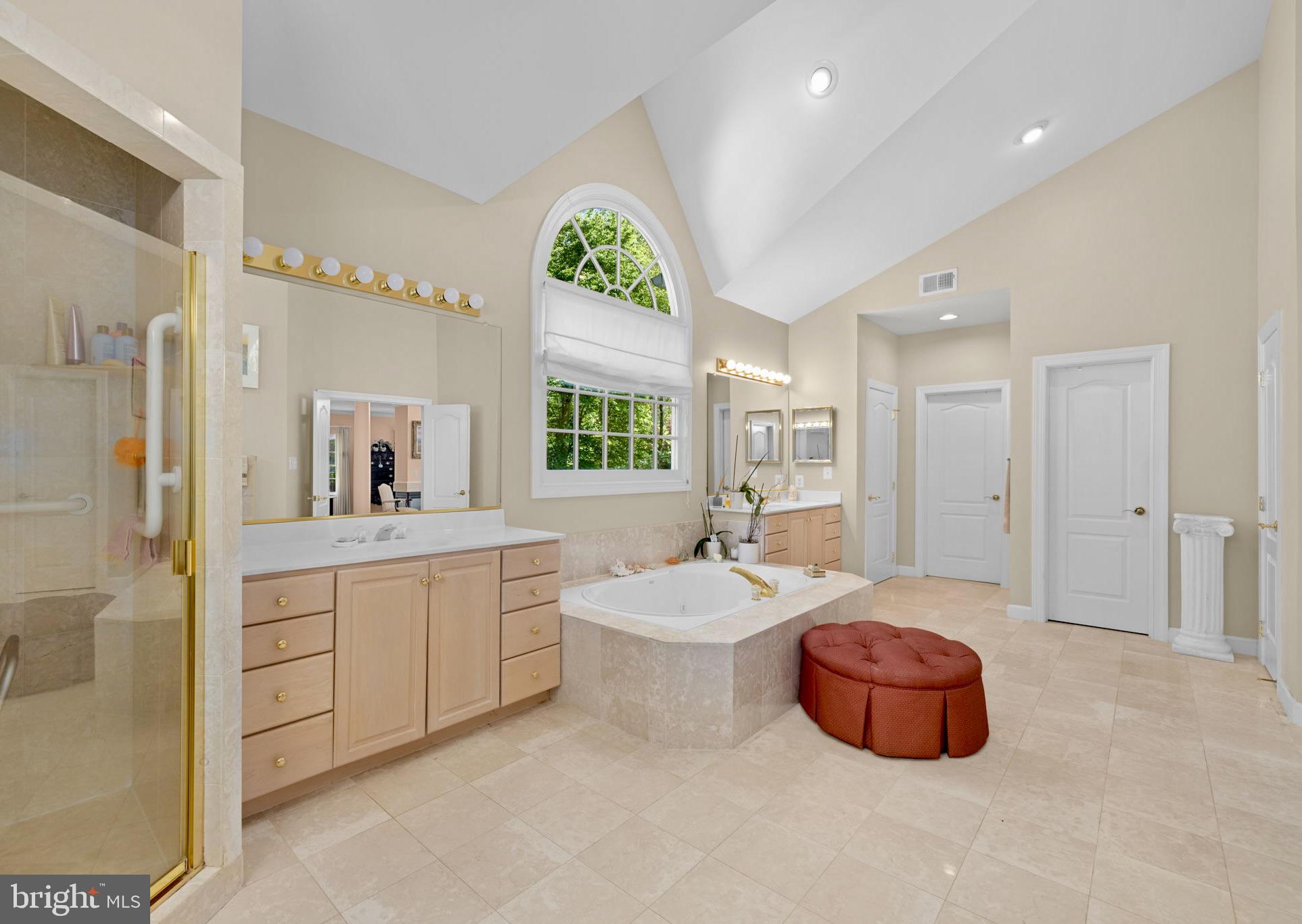 897 Chinquapin Road McLean, VA 22102 - Photo 41 of 66 a spacious bathroom with a double vanity sink a mirror and a bathtub