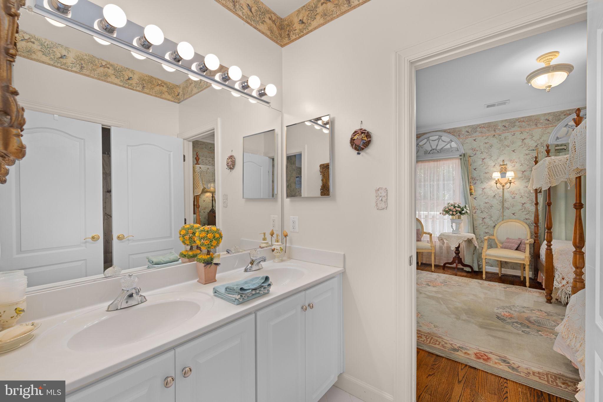 897 Chinquapin Road McLean, VA 22102 - Photo 46 of 66 a en suite bathroom with a double vanity sink mirror and