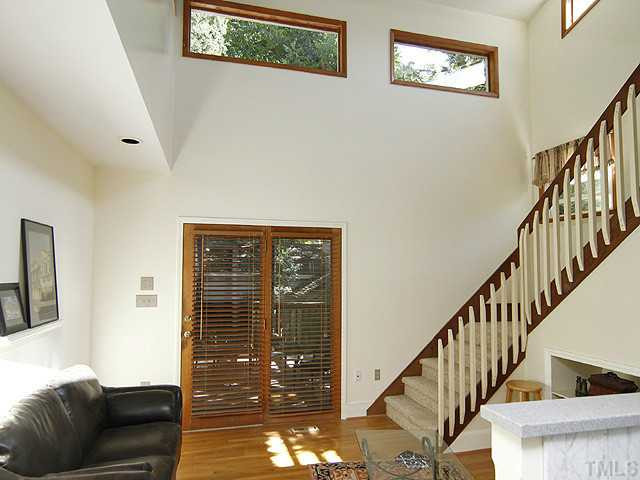 309 Cedar Street Raleigh, NC 27604 - Photo 11 of 25 Family room is light and bright with stairs leading to the loft/office, 3rd bedroom and lots of walk-in attic storage. Den/Family/Great Room
