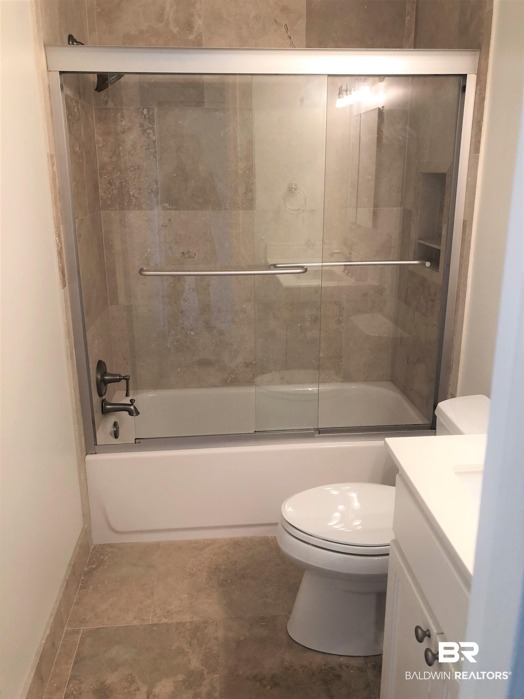 4009 Old Shell Road, Unit C12 Mobile, AL 36608 - Photo 9 of 11 Full bathroom featuring bath / shower combo with glass door, vanity, and toilet