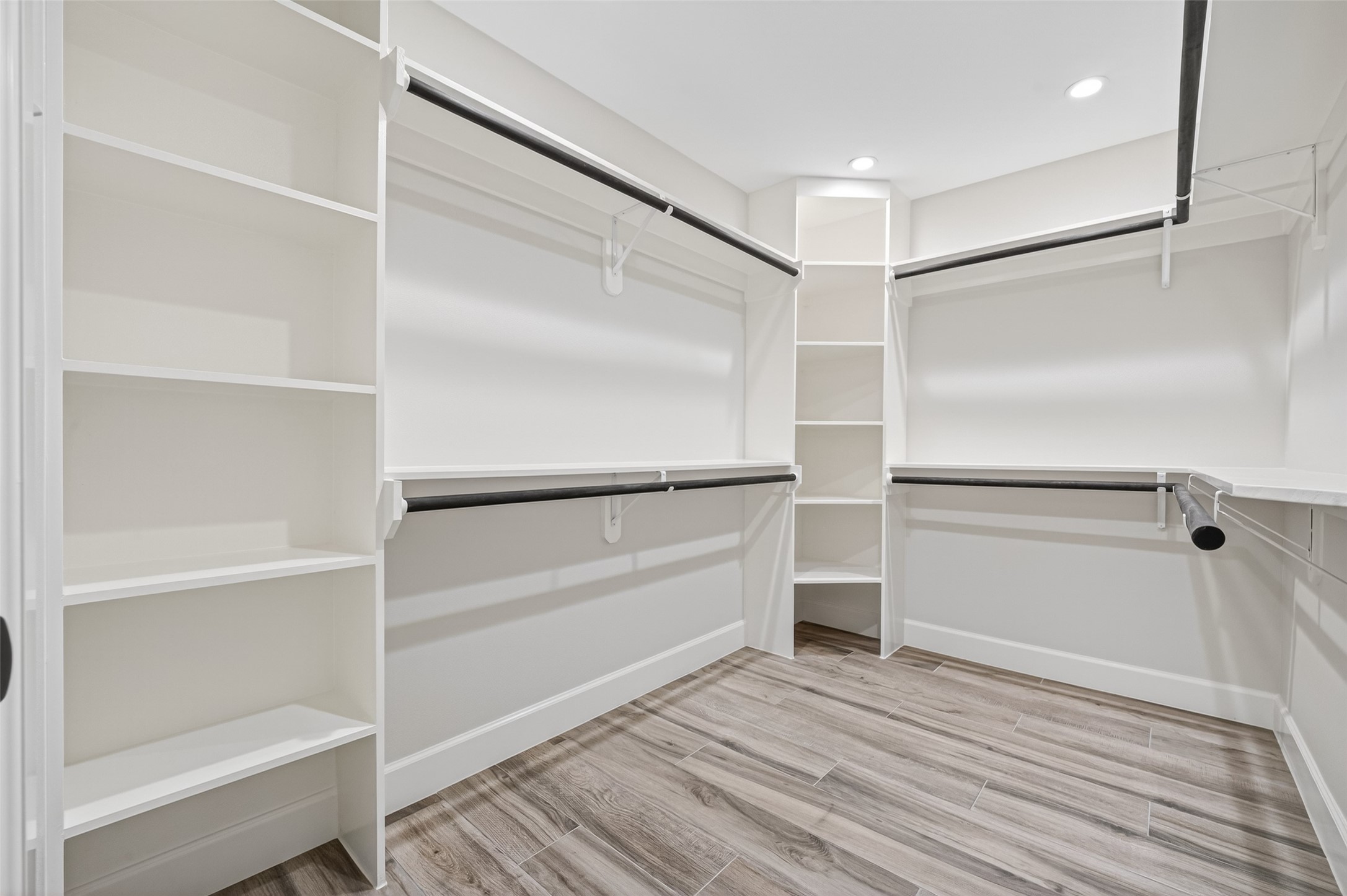 23607 Cardinal Drive Hockley, TX 77447 - Photo 23 of 50 A comprehensive full-entry closet features wrap-around built-in shelving and hanging rods, designed to accommodate a professional-grade wardrobe.