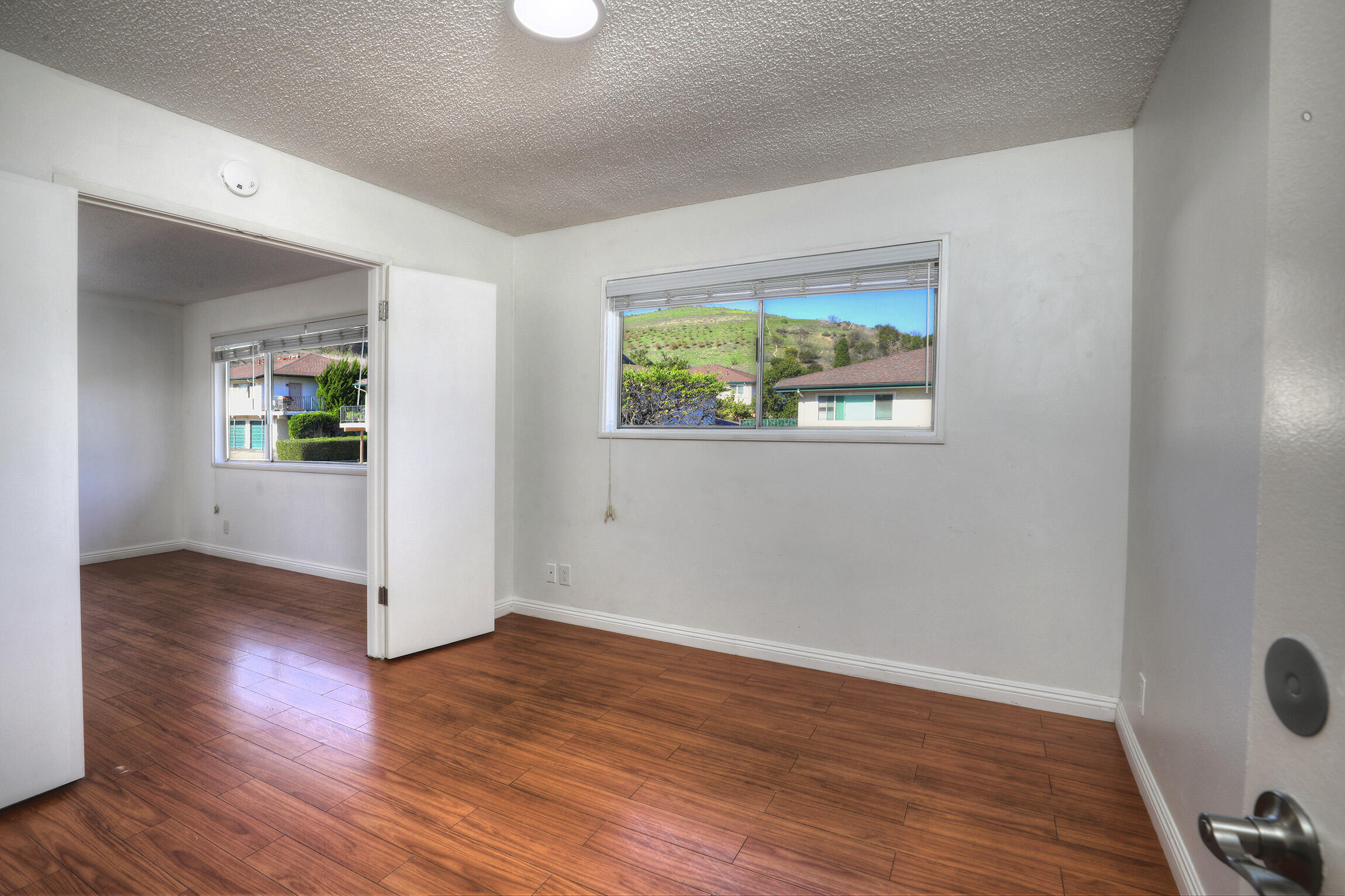 361 Northgate Drive, Unit D Goleta, CA 93117 - Photo 16 of 22 an empty room with wooden floor and windows