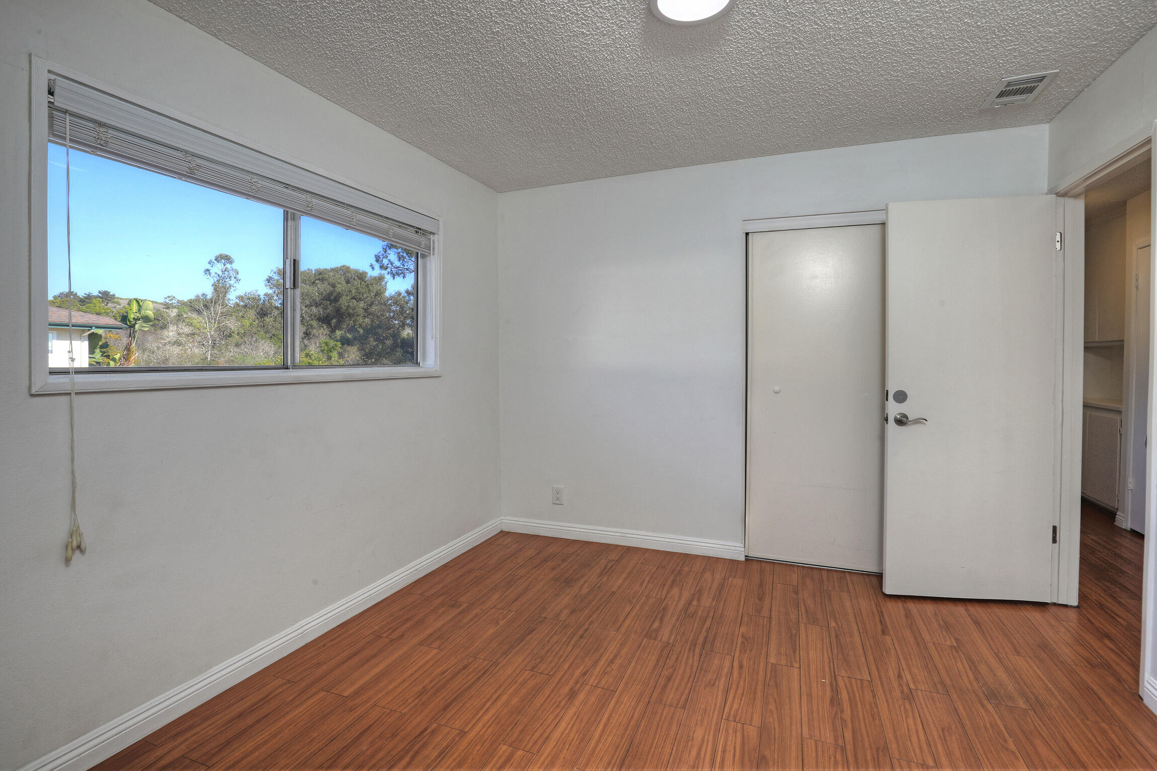 361 Northgate Drive, Unit D Goleta, CA 93117 - Photo 17 of 22 an empty room with wooden floor and a window