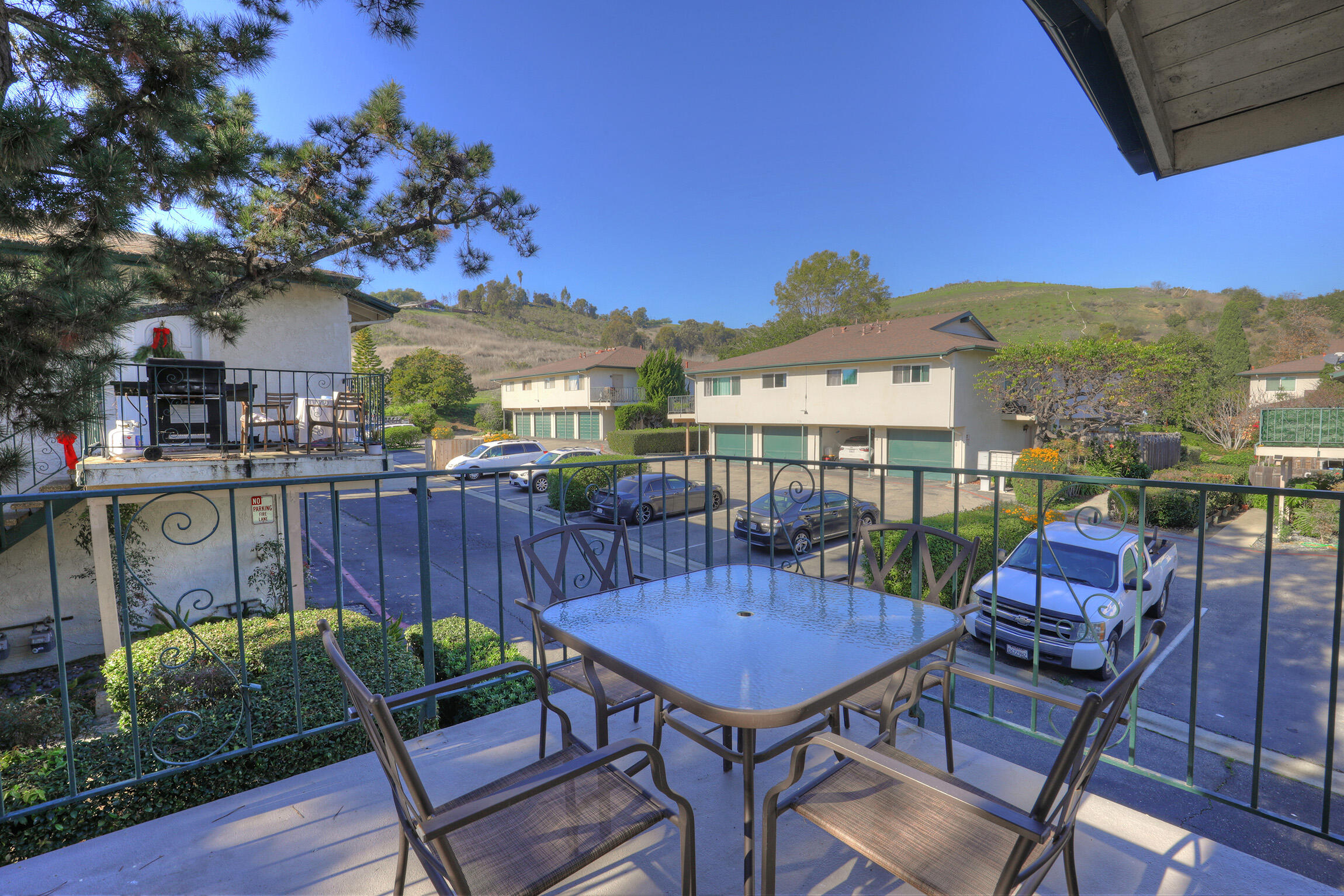 361 Northgate Drive, Unit D Goleta, CA 93117 - Photo 2 of 22 a view of a patio with couches table and chairs under an umbrella with a barbeque