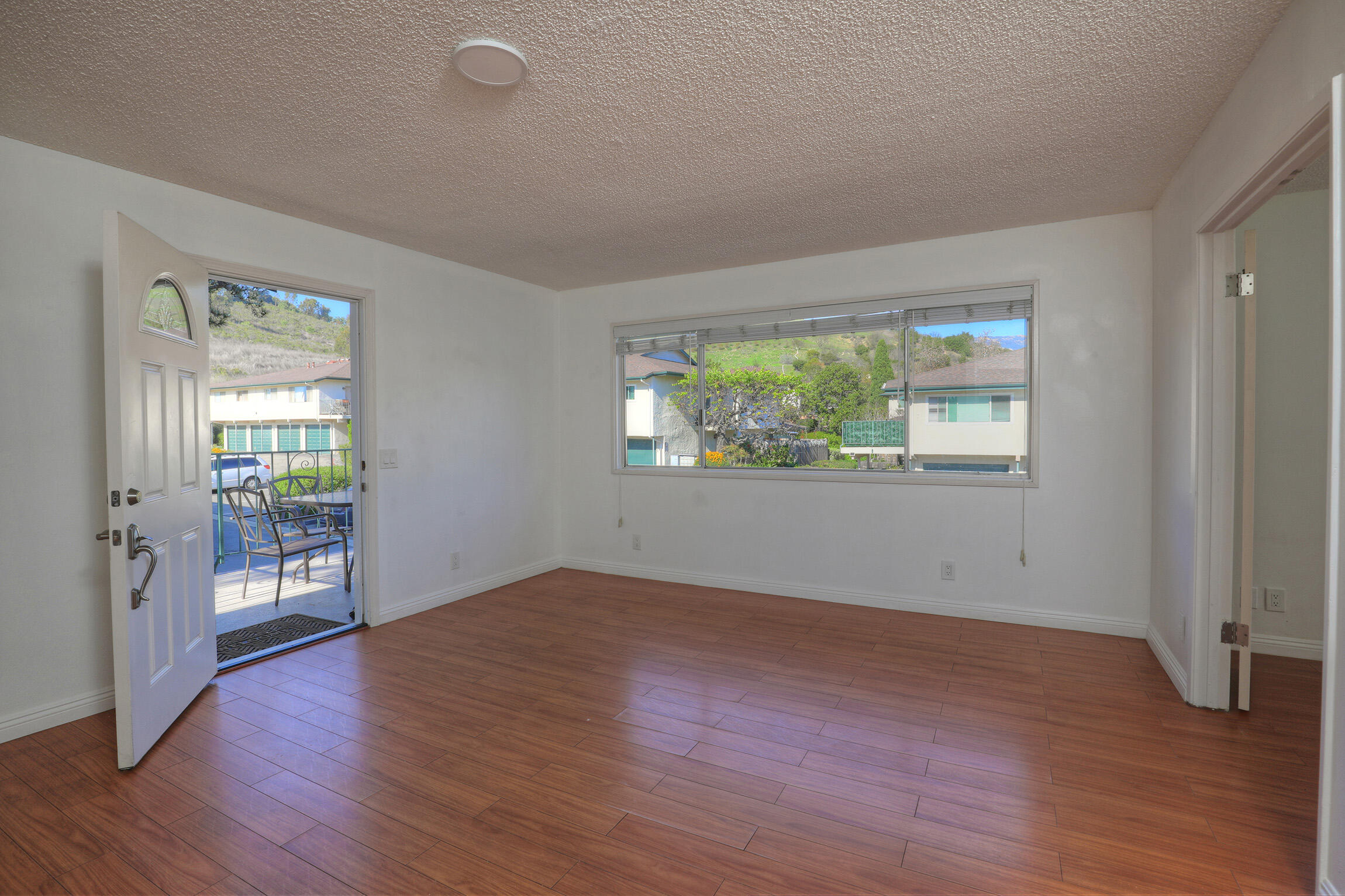 361 Northgate Drive, Unit D Goleta, CA 93117 - Photo 3 of 22 an empty room with wooden floor and windows