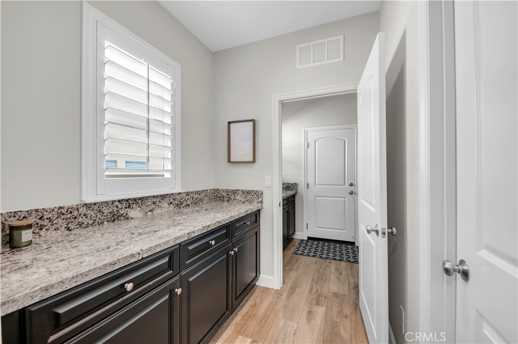 33303 Barmetta Lane Temecula, CA 92592 - Photo 23 of 46 a view of a kitchen counter space and wooden floor