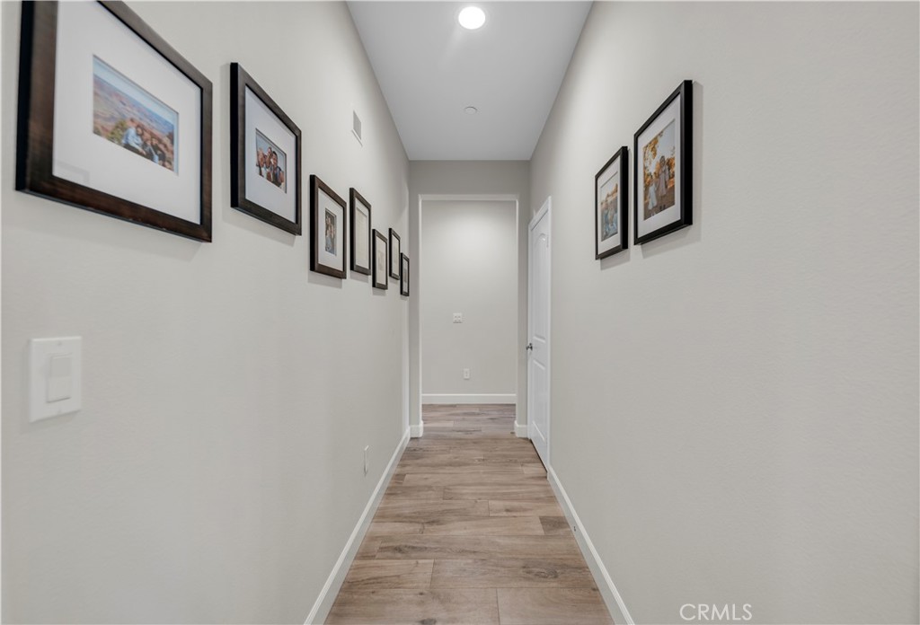 33303 Barmetta Lane Temecula, CA 92592 - Photo 25 of 46 a view of a hallway with paintings on the wall