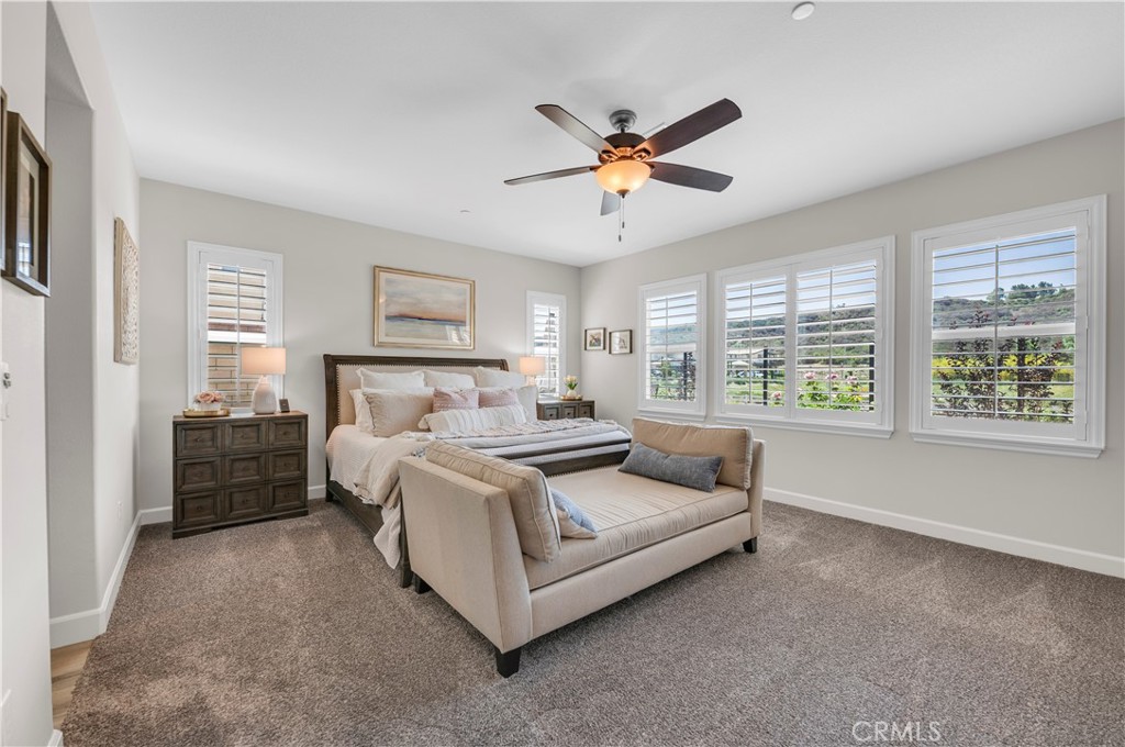 33303 Barmetta Lane Temecula, CA 92592 - Photo 27 of 46 a bed room with a bed and a chandelier