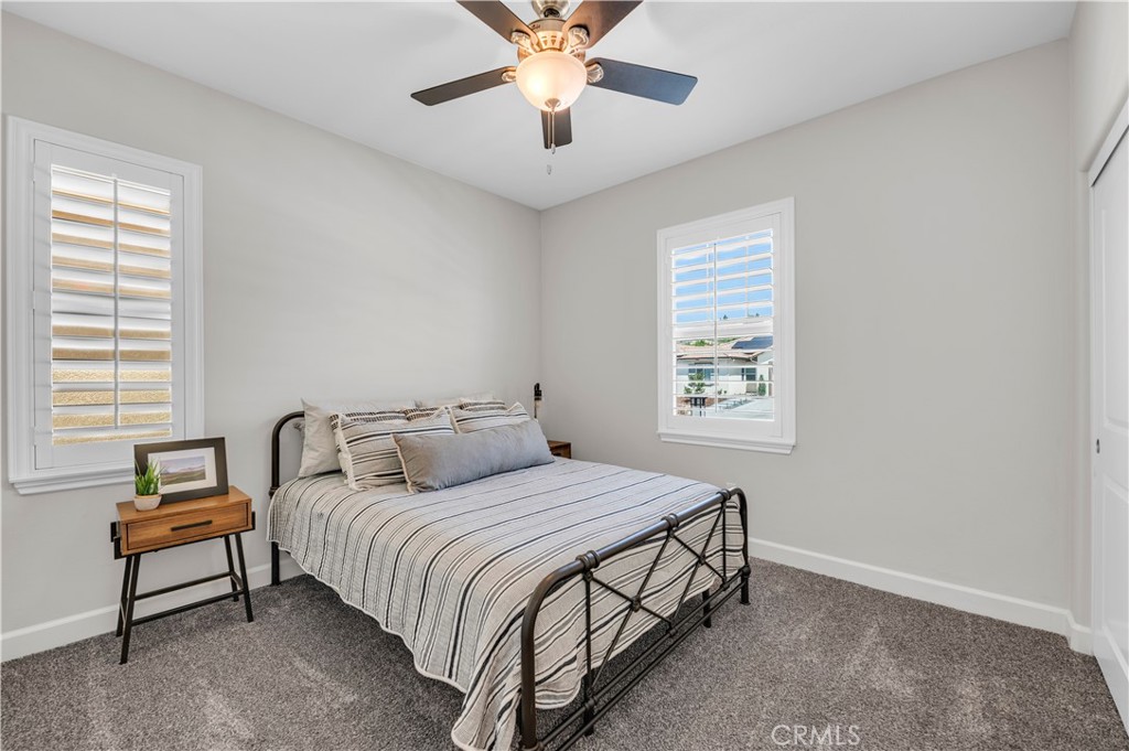 33303 Barmetta Lane Temecula, CA 92592 - Photo 32 of 46 a bedroom with a bed and a chandelier