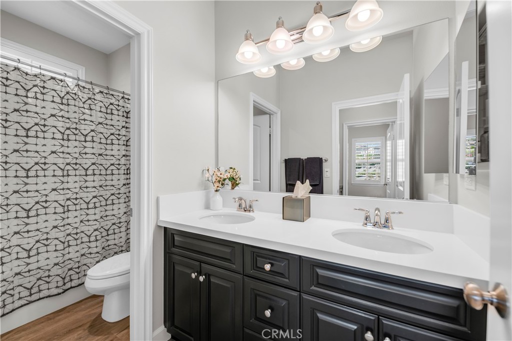 33303 Barmetta Lane Temecula, CA 92592 - Photo 33 of 46 a bathroom with a sink a toilet and a mirror