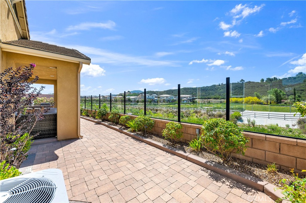33303 Barmetta Lane Temecula, CA 92592 - Photo 38 of 46 a view of a house with a big yard and potted plants