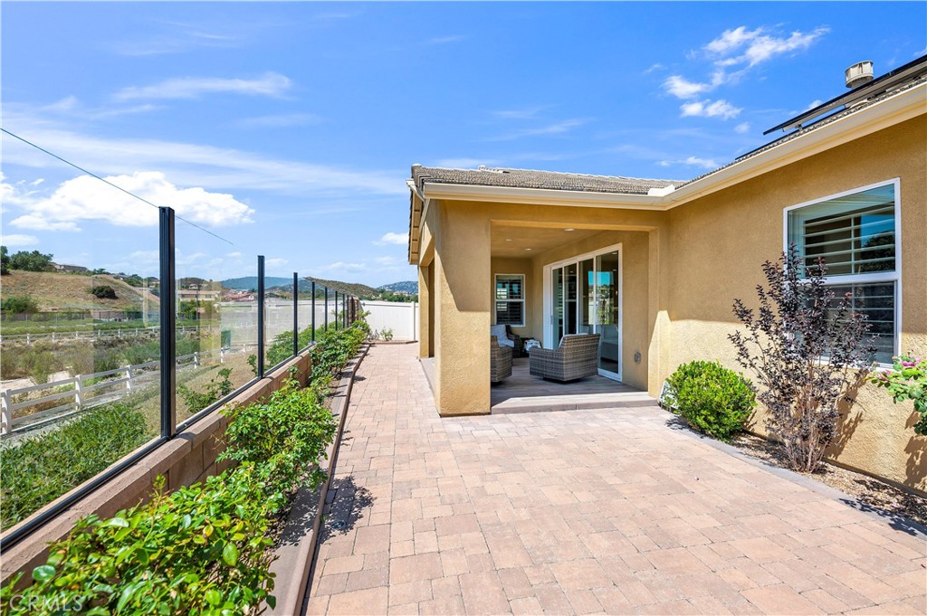 33303 Barmetta Lane Temecula, CA 92592 - Photo 40 of 46 a view of a house with a porch and furniture