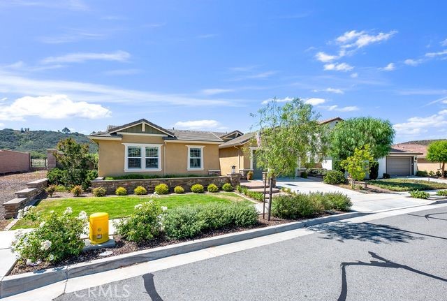 33303 Barmetta Lane Temecula, CA 92592 - Photo 5 of 46 a front view of a house with a yard