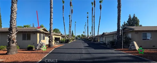 a view of street along with house and trees