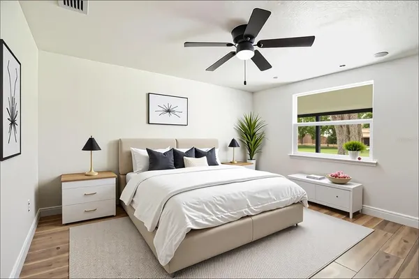 a bedroom with a bed and a painting on the wall