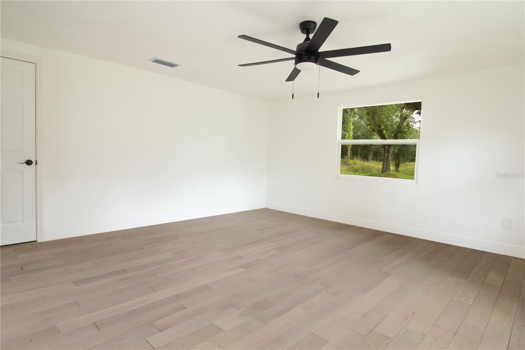 39912 Jerry Road Zephyrhills, FL 33540 - Photo 28 of 59 an empty room with a window and a fan