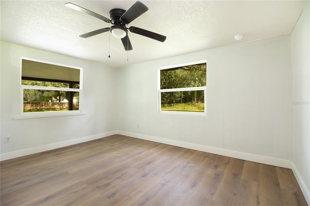 39912 Jerry Road Zephyrhills, FL 33540 - Photo 29 of 59 an empty room with ceiling fan and windows