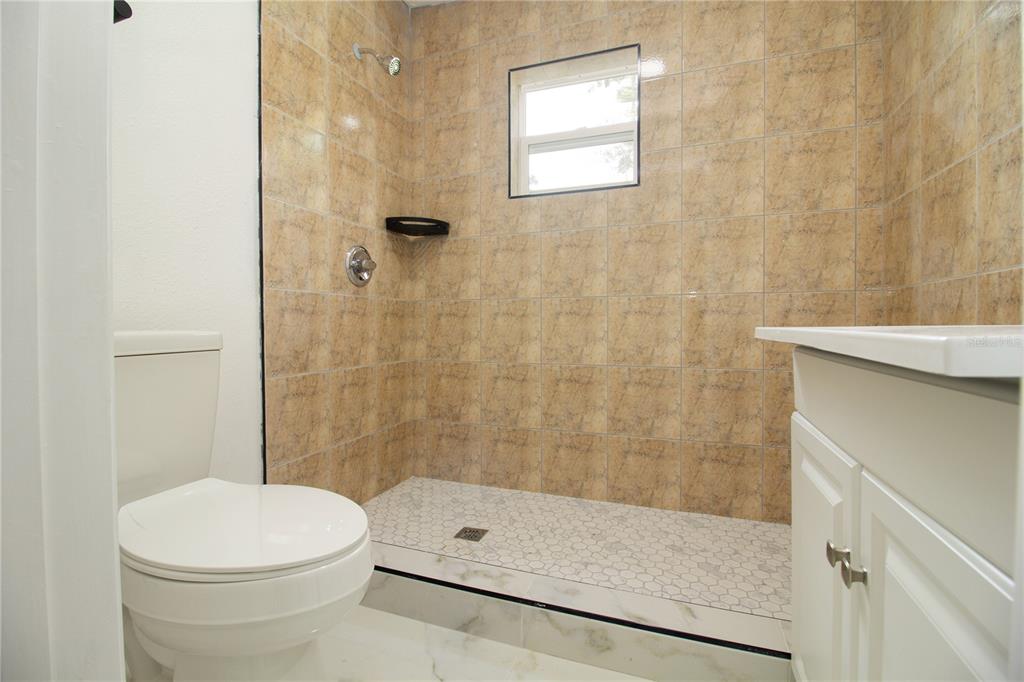 39912 Jerry Road Zephyrhills, FL 33540 - Photo 36 of 59 a bathroom with a toilet and shower