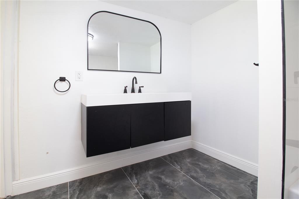 39912 Jerry Road Zephyrhills, FL 33540 - Photo 38 of 59 a bathroom with a sink and a mirror