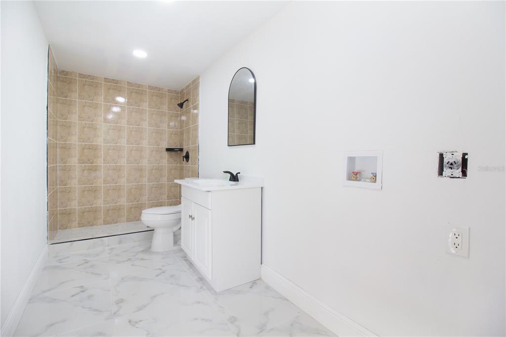 39912 Jerry Road Zephyrhills, FL 33540 - Photo 47 of 59 a bathroom with a toilet sink and mirror