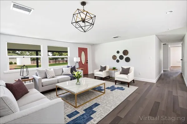 a kitchen with granite countertop a sink and white cabinets