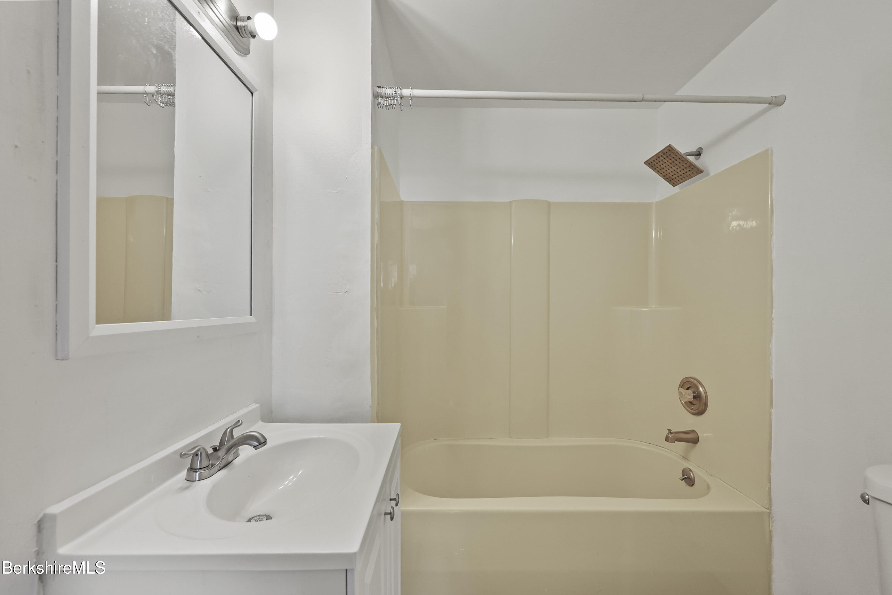55 Crystal Street, Unit 8 Lenox, MA 01242 - Photo 12 of 12 a white bath tub with a sink