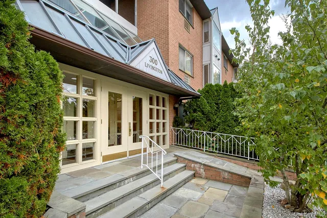 a view of a house with a small deck