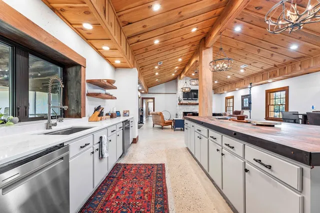 a kitchen with a stove and a wooden cabinets